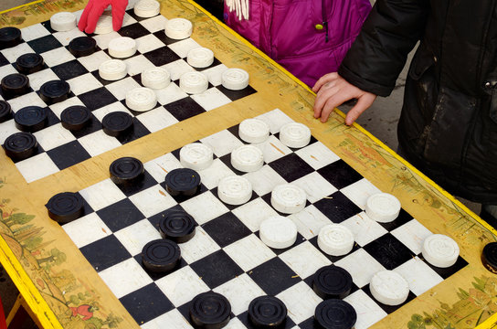 The game of checkers on the street.