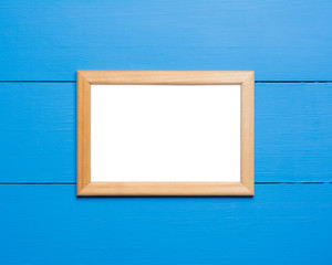 Empty photo frame over blue painted background