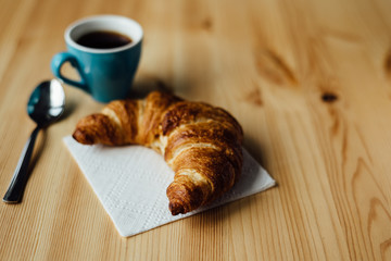 Breakfast with coffee and croissant