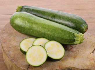 green zucchini vegetables on wooden background