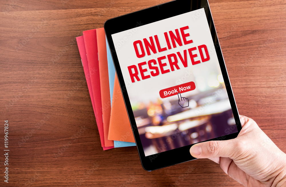 Poster top view of hand holding tablet with online reserved word with b