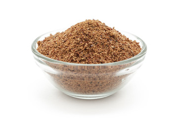 Organic powder of Indian Jujube (Ziziphus mauritiana) in a glass bowl. Isolated on white background. Front view.