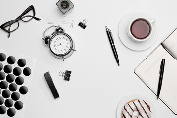 The clock, pen, and glasses on white background