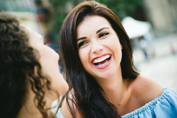 Beautiful young women talking in the street.