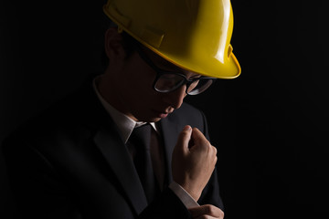 Engineer in black suit on isolated black background