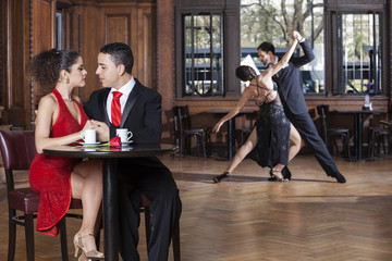 Couple Looking At Each Other While Tango Partners Performing
