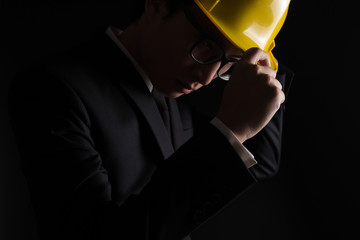 Engineer in black suit on isolated black background