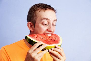 young man eating watermelon