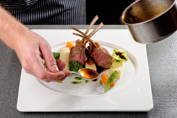 Male chef garnishing his dish, ready to serve