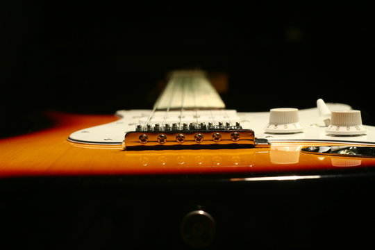 Vintage electric guitar on black background