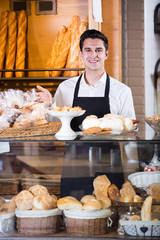 Fototapeta na wymiar Cheerful man selling tarts and sweet pastry