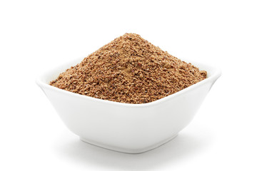 Organic powder of Indian Jujube (Ziziphus mauritiana) in a white ceramic bowl. Isolated on white background. Front view.