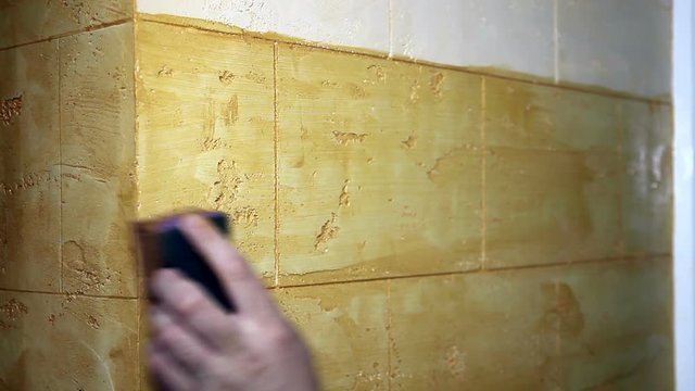 Man's Hand Painting A Wall  With a Sponge