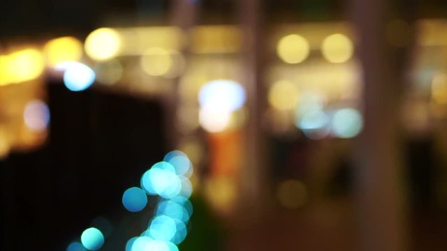 Blur holiday light bokeh background with people shadow walking 