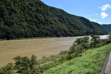 Fototapeta na wymiar 日本三大急流　最上川 ／ 山形県内の源流から河口まで流れる日本三大急流の一つ、最上川を撮影した写真です。一つの都府県のみを流域とする河川としては、延長229kmと国内最長の河川です。撮影当日は前日の大雨により増水し濁っていました。