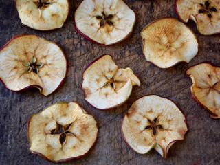 Wooden dried apples in the background. selective focus
