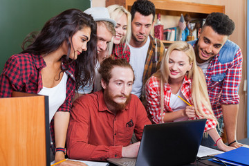 Student High School Group With Professor Using Laptop Computer Sitting At Desk, Young People Teacher Discuss