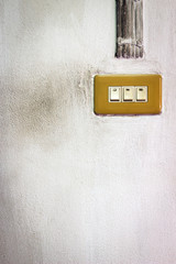 Old switch on cement wall 