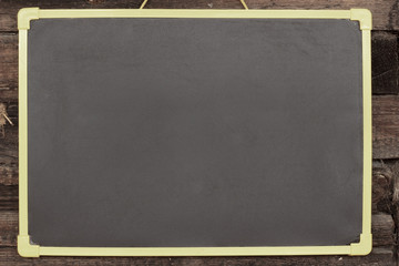 Obraz premium Chalk board hanging on wooden background