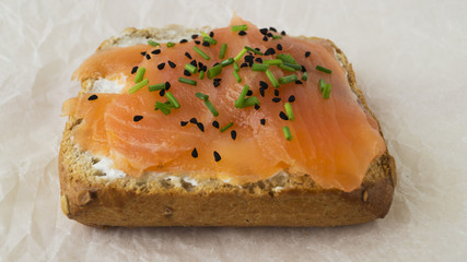 Smoked salmon and soft cheese sandwich with nigella seeds and sp