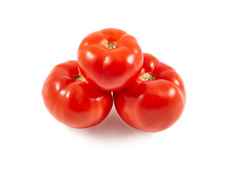 A tomato. Red tomato on a white background. Harvest vegetables. Autumn harvest. Red, juicy, ripe tomato.