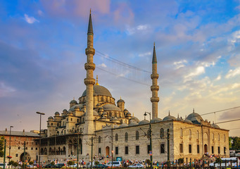 Fototapeta na wymiar New mosque - Yeni Cami against the cloudy sky at sunset in Eminonu district of Istanbul, Turkey