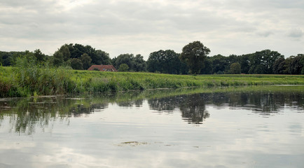 Dutch river de Berkel with dyke and farm. Achterhoek. Gelderland