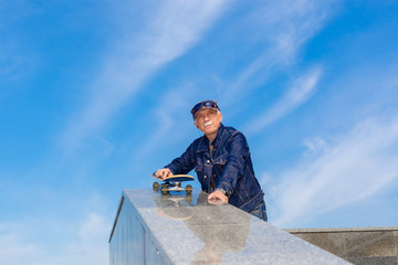 energetic senior man enjoying riding a skateboard