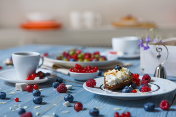 Breakfast with baked pea and berries at blue rustic wood