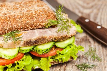 Tasty rye bread sandwiches with roast meat and vegetables