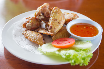 Traditional Thai fired chicken wing close up.