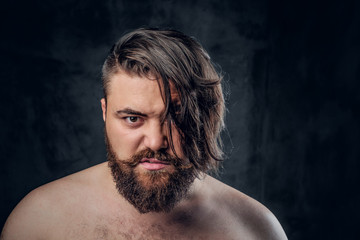 Portrait of bearded male on grey background.