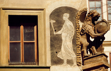 Gothic patterned facade of a building with historical fresco and gargoyle