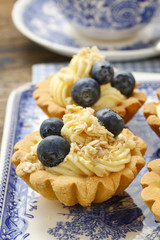 Cupcakes with vanilla cream and blueberries