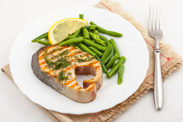 grilled salmon steak in plate on the table