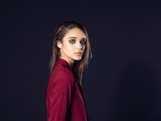 Fashion photo of young beautiful woman on black background.