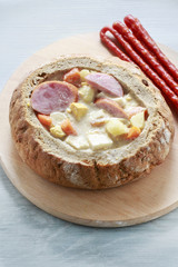 The sour rye soup inside loaf of bread.
