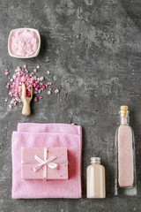 Fototapeta na wymiar Spa set: liquid soap, bar of handmade soap, sea salt and towel.