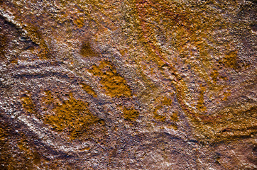 Rainbow oil slick on the sand. Textured background. Pollution of water and ground concept.