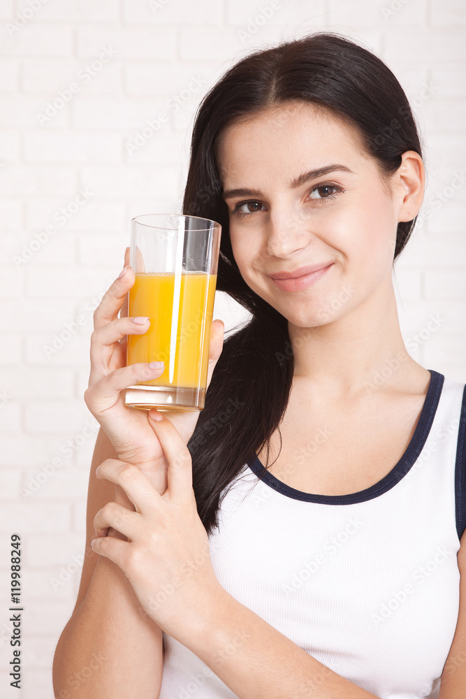 Wall mural woman drinking orange juice beautiful mixed-race asian, caucasian model.