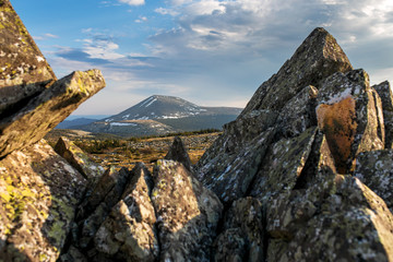 Top of the Iremel mountain by rays of the rising sun. South Ural