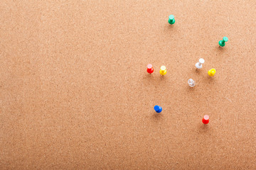 Pins on brown cork board