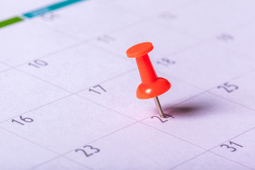 Concept image of a calendar with red push pin