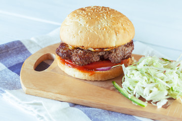 home made burgers on wooden background