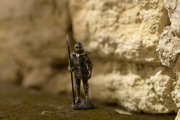 Metal soldier holding an engagement ring on his neck