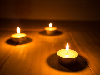 yellow candle soft lighting on wooden background