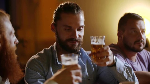 Happy old friends meeting in a bar tell stories and toasting beer