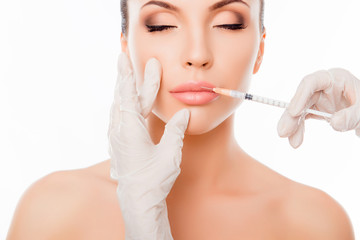 Plastic surgery. Young woman geting cosmetic injection in lips
