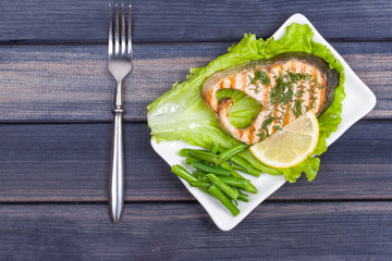 portion of grilled salmon steak top view