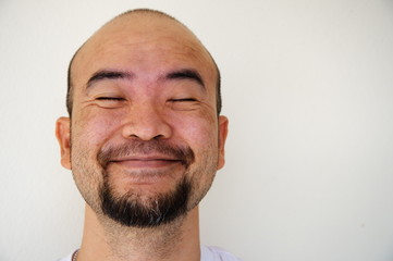 happy smiling beard bald asia man on white background